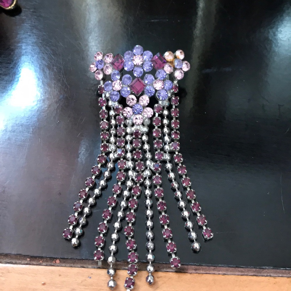Shades of purple rhinestone charm add a chain